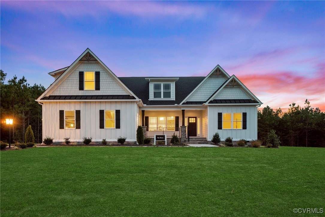 a front view of a house with a yard and green space