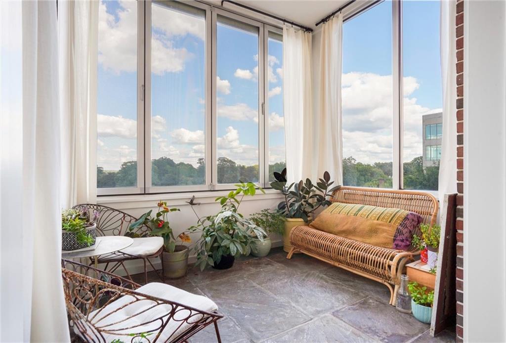 a bedroom with furniture and a large window