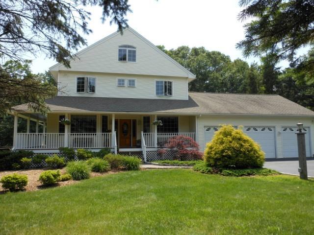 a front view of a house with a garden and plants