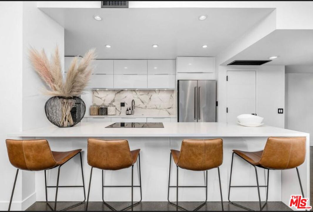 a kitchen with a dining table and chairs