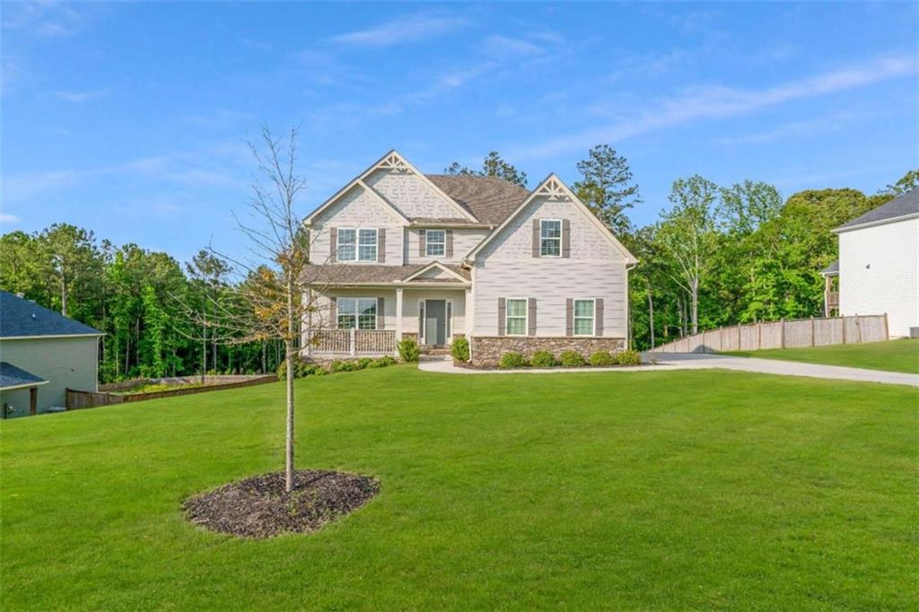 a front view of a house with a garden