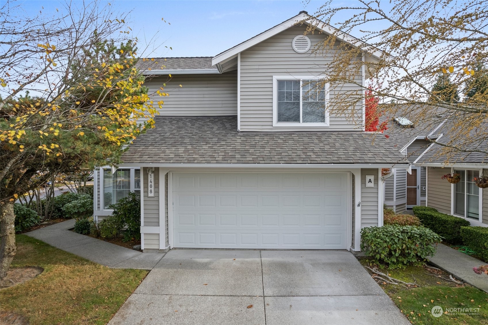 a front view of house with yard and trees around