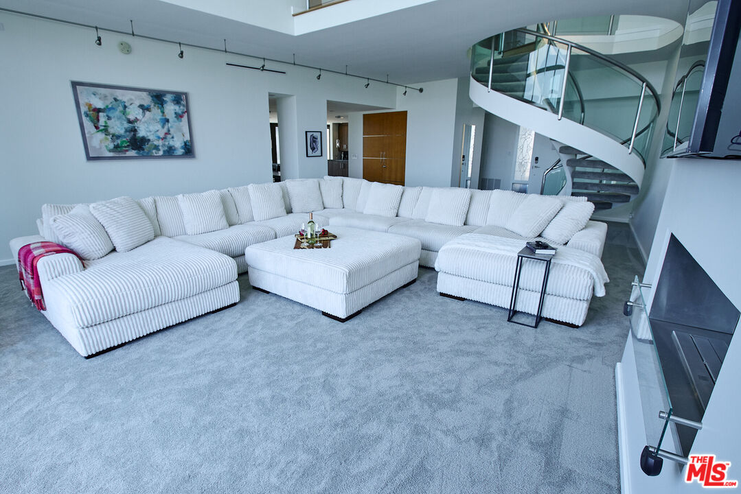 a living room with furniture and a painting on the wall