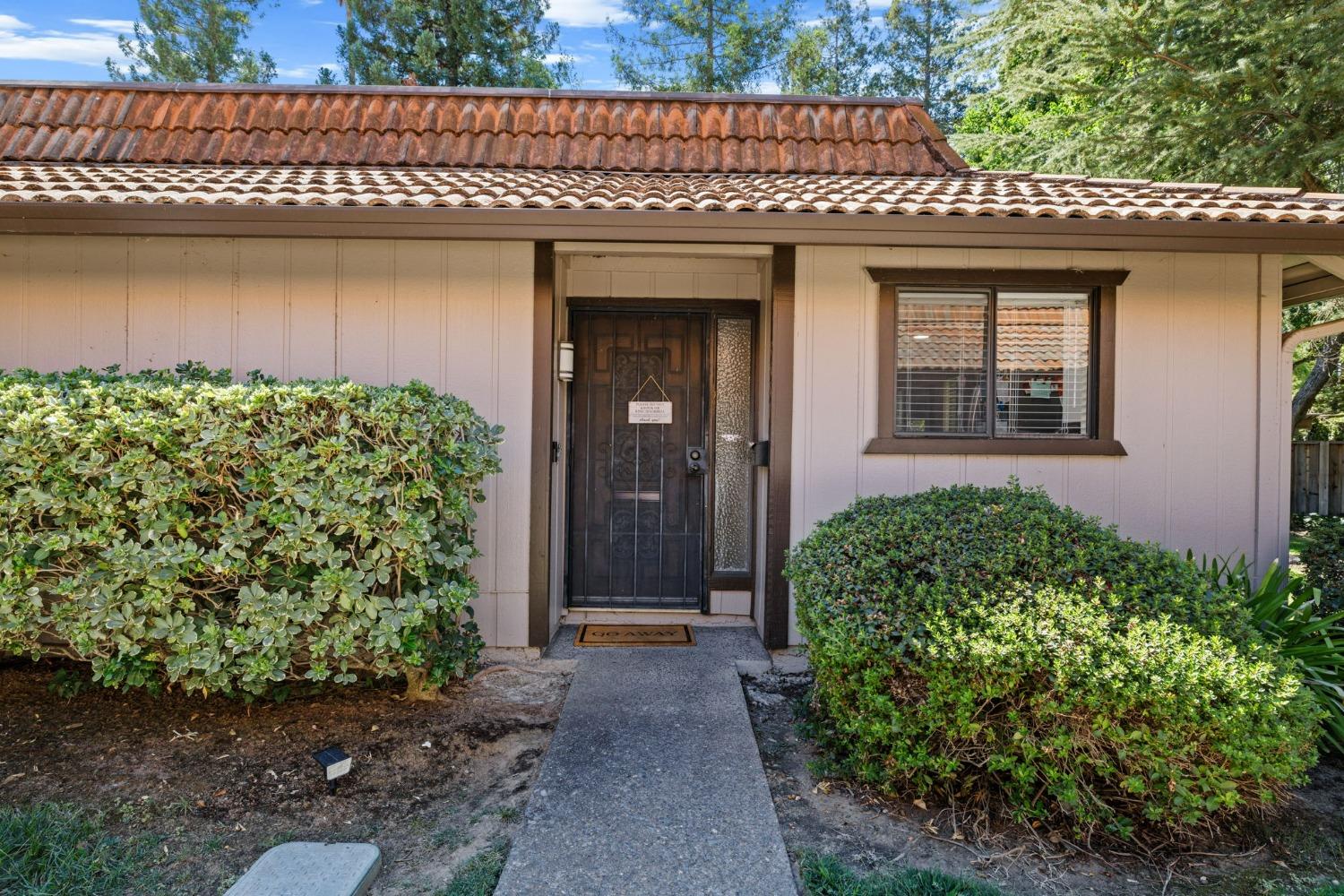 a front view of a house with garden