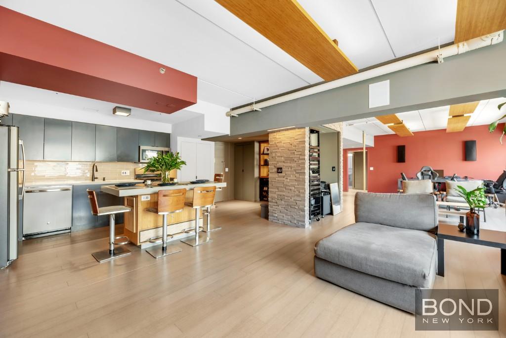 a living room with furniture and kitchen view