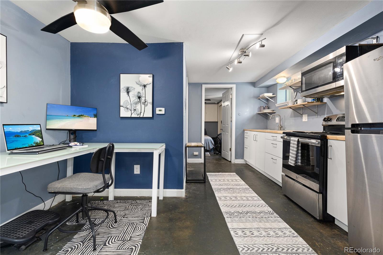 a kitchen with stainless steel appliances kitchen island granite countertop a sink and cabinets