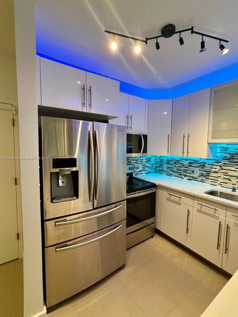 a kitchen with granite countertop stainless steel appliances and counter space