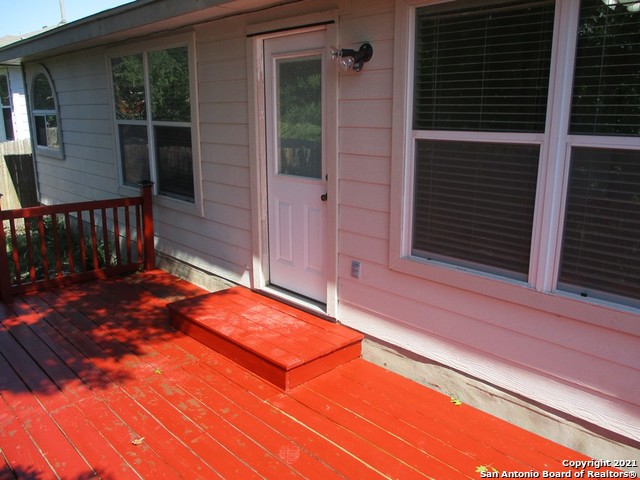 a view of backyard with deck and wooden floor