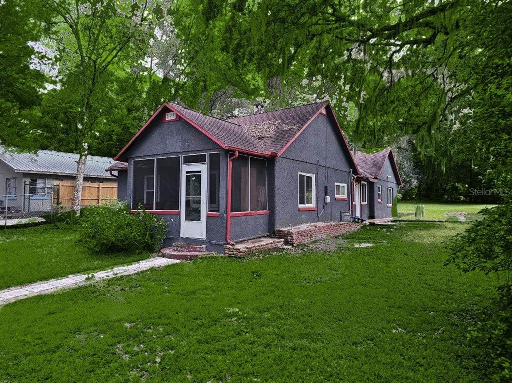 a front view of a house with a garden and yard