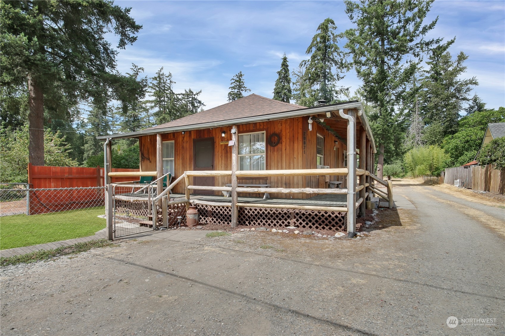 a view of backyard with deck and trees