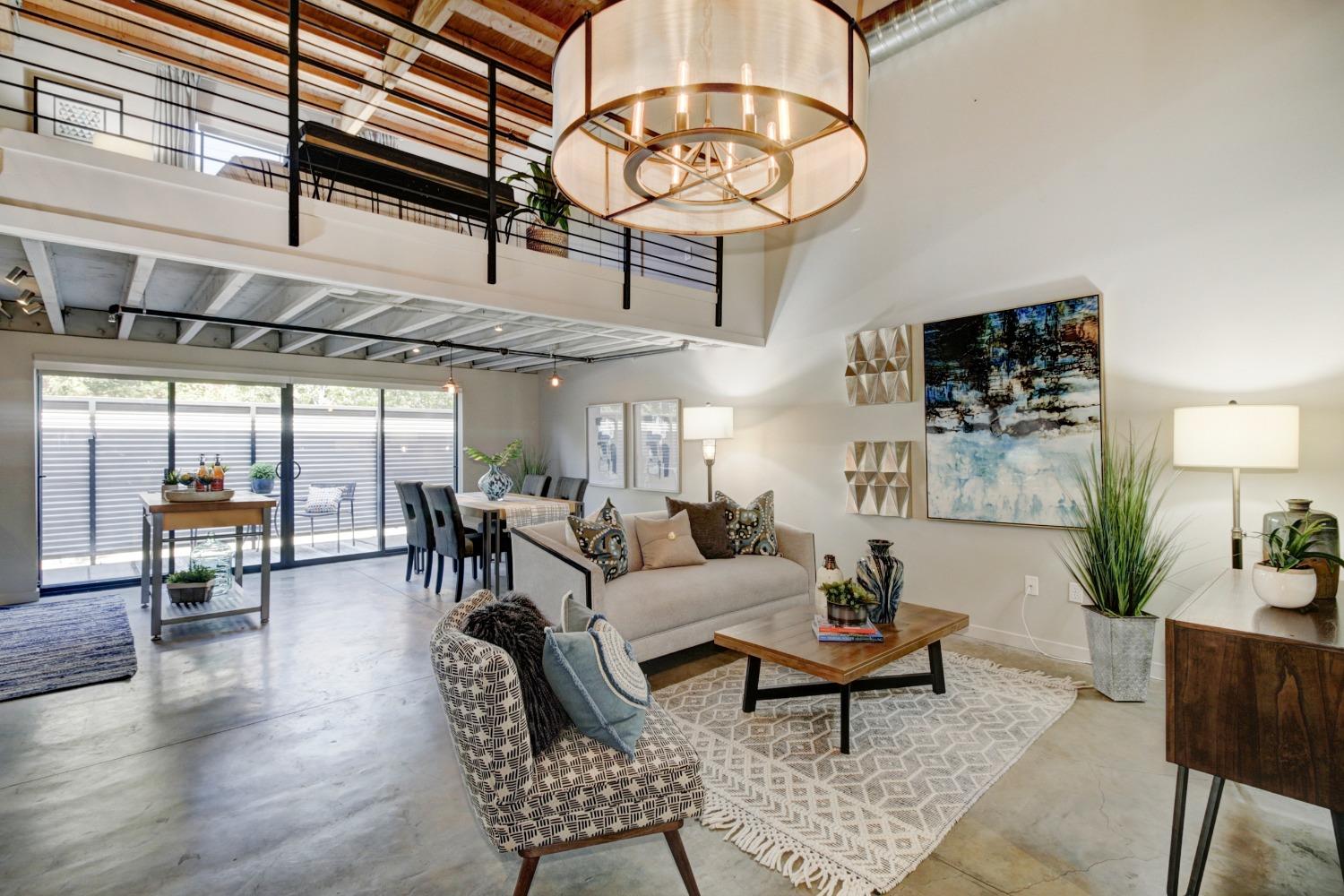 a living room with furniture a chandelier and a table