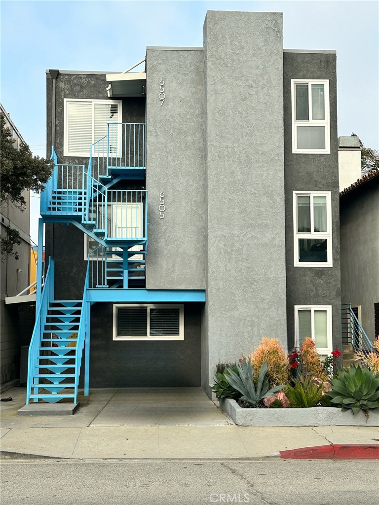 a front view of a house with plants