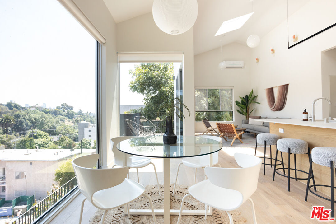 a dining room with furniture a chandelier and wooden floor