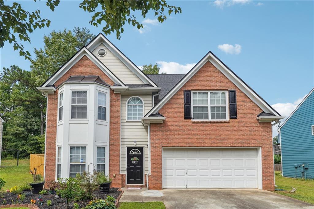 a front view of a house with garage