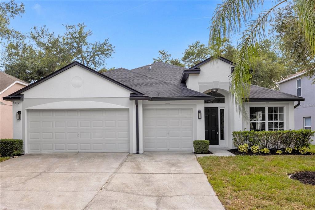 a front view of a house with a yard and garage