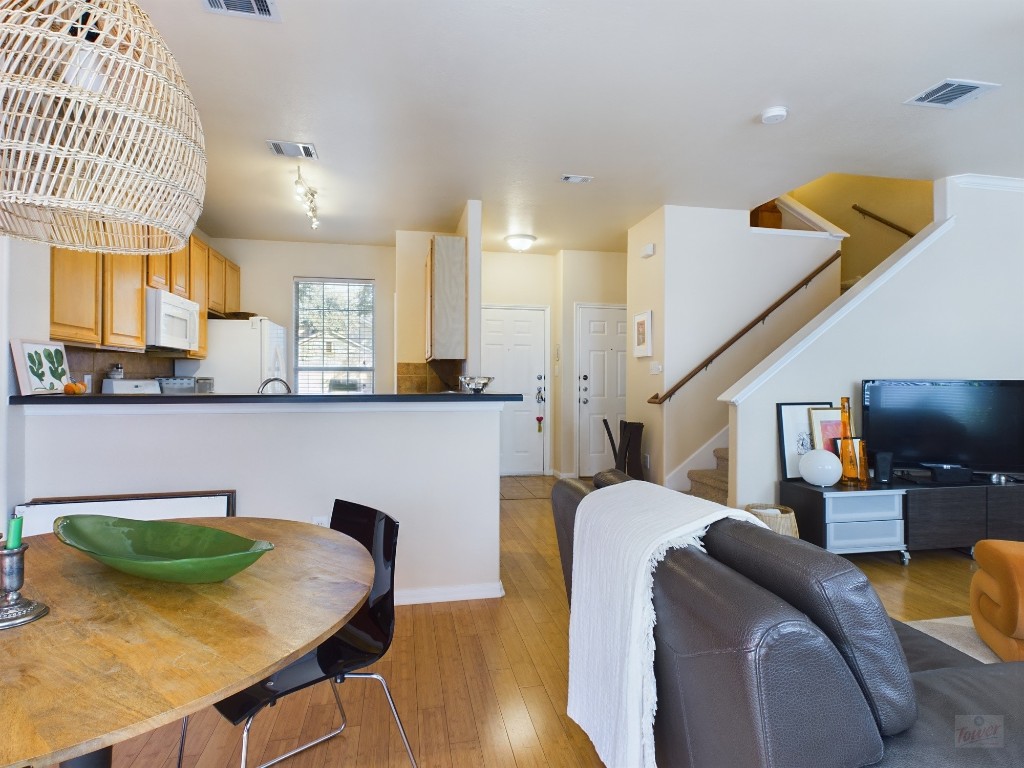 a living room with furniture and a wooden floor