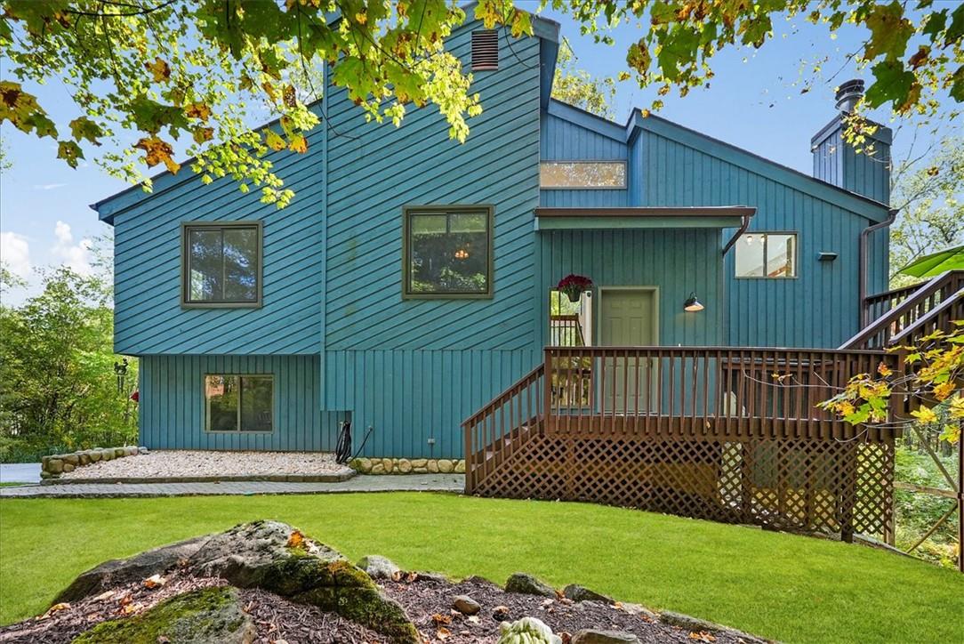 a view of a house with a swimming pool and a yard