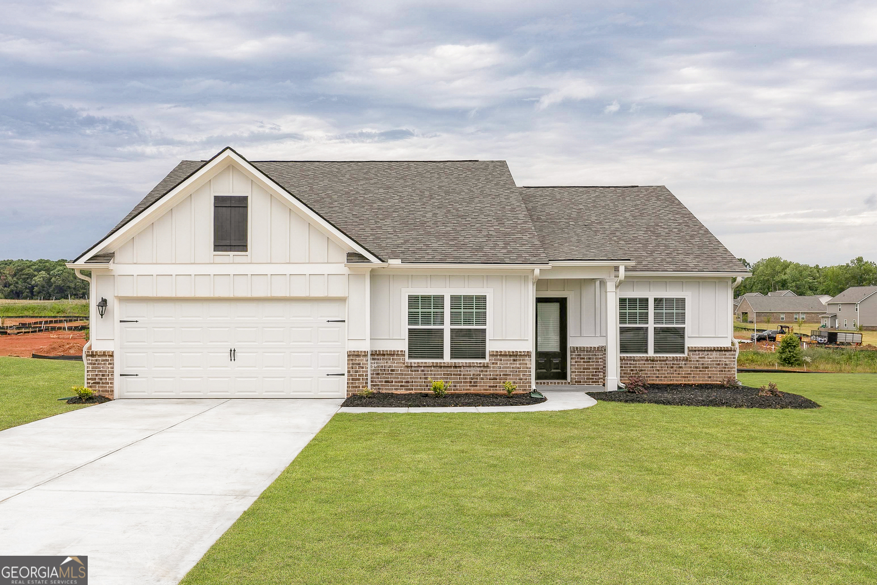 a front view of house with yard and green space