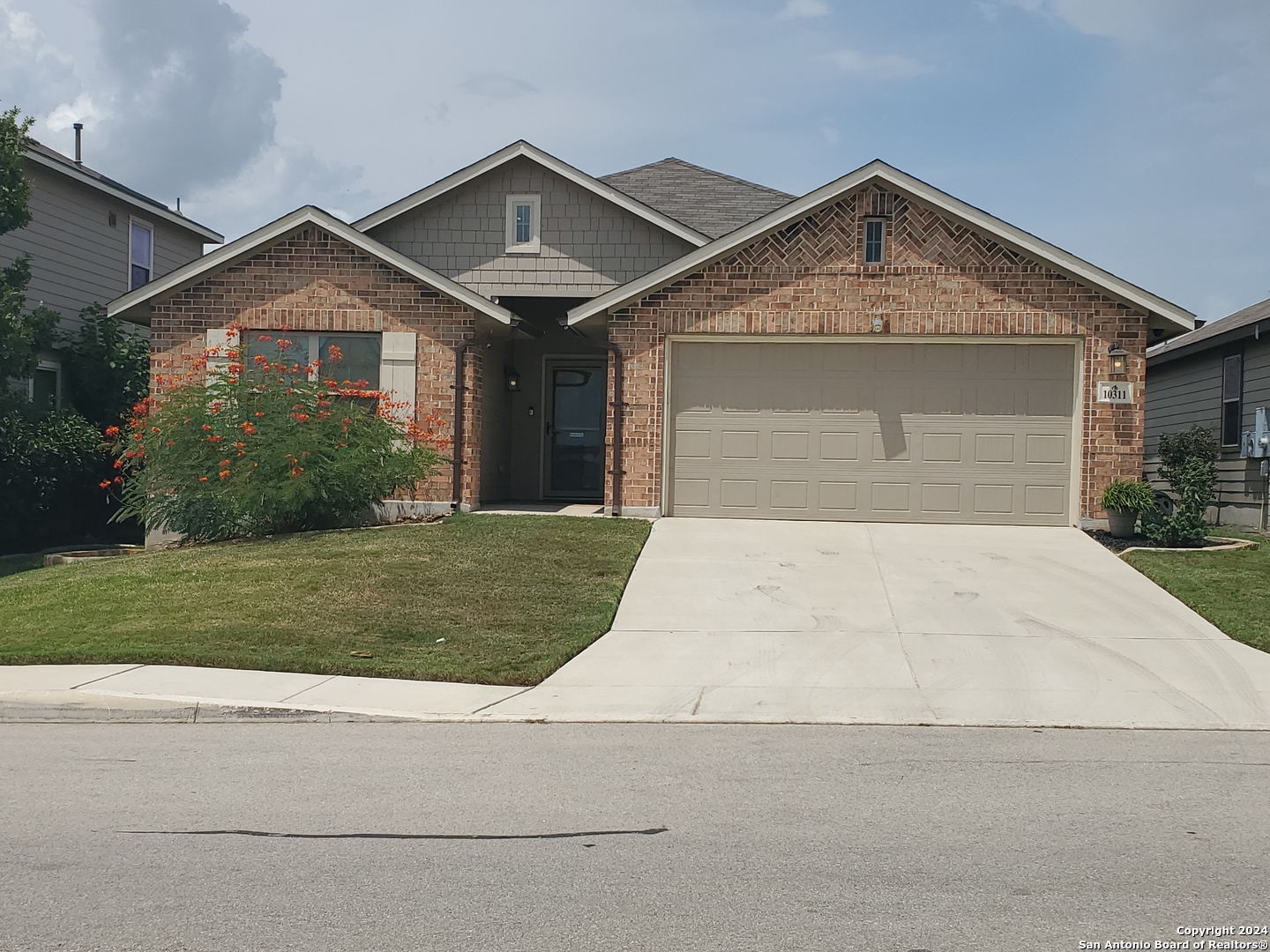 a front view of a house with a yard