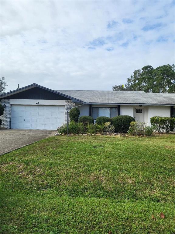 a front view of house with yard and outdoor seating