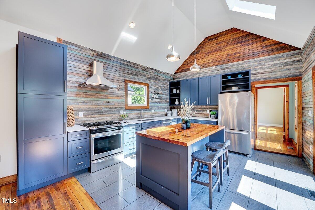 a kitchen with stainless steel appliances granite countertop a stove and a refrigerator