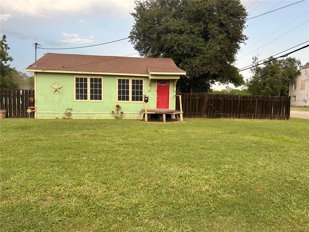 a view of a house with a yard and sitting area