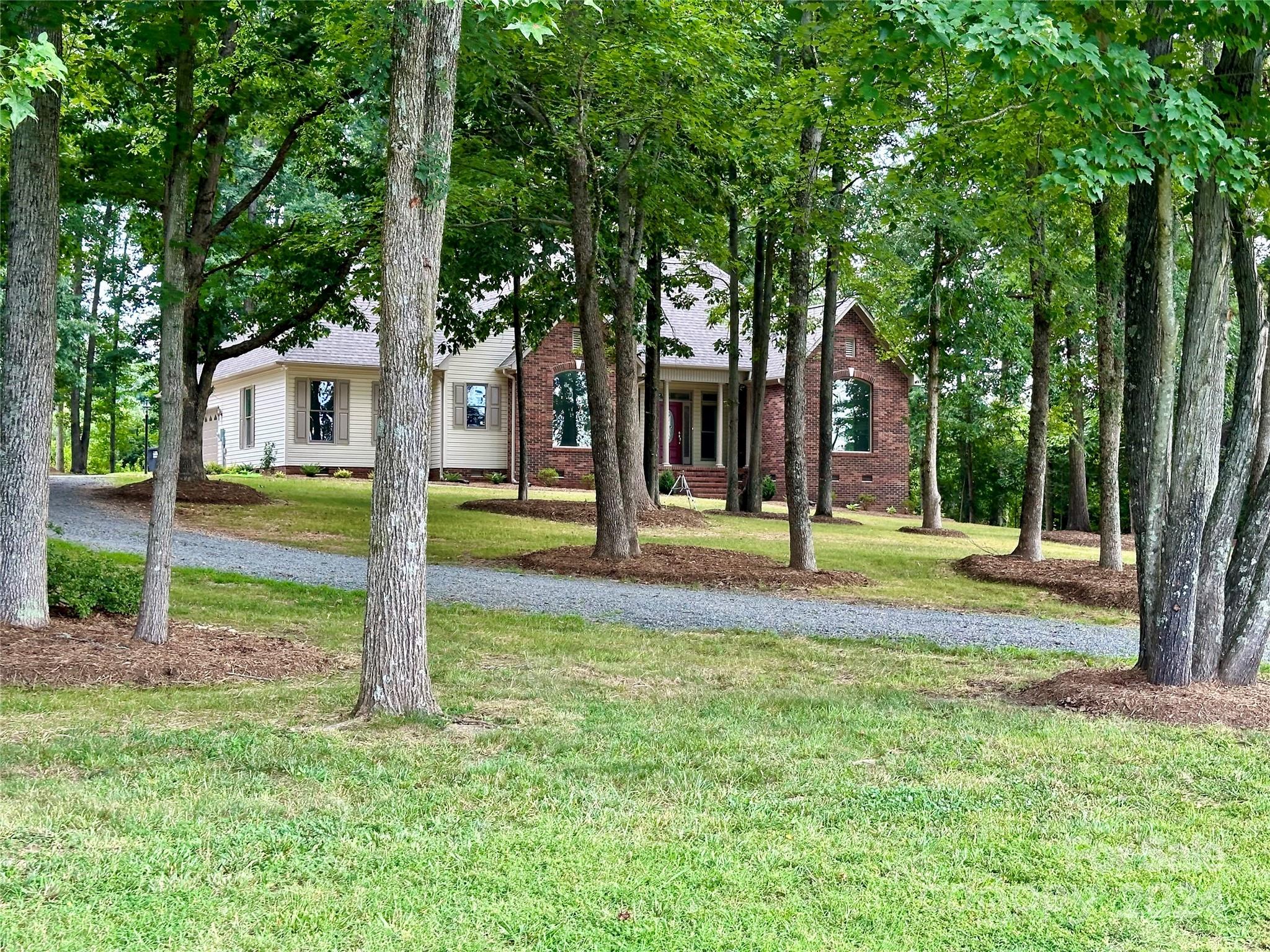 a view of a house with backyard and tree