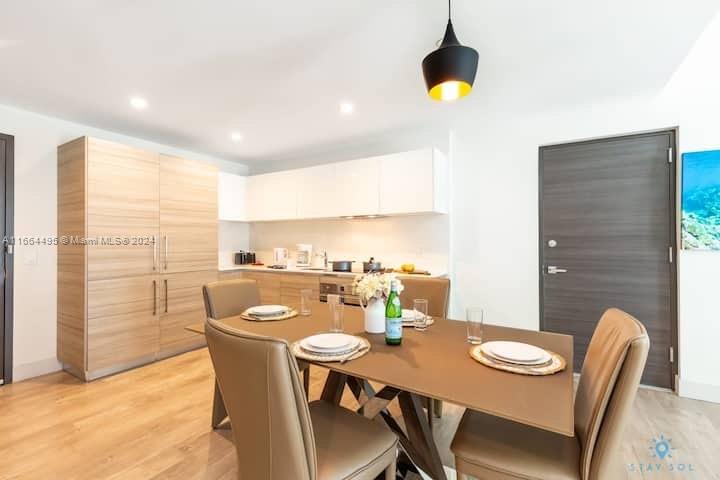 a view of a dining room with furniture and wooden floor