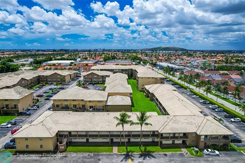 a view of multiple houses with yard