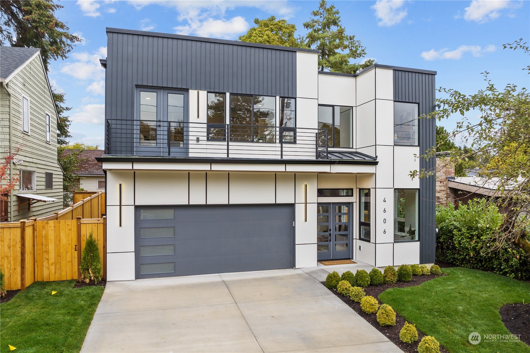 a front view of a house with a garden and garage