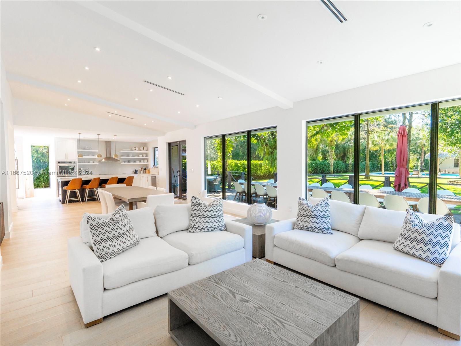 a living room with furniture and large windows