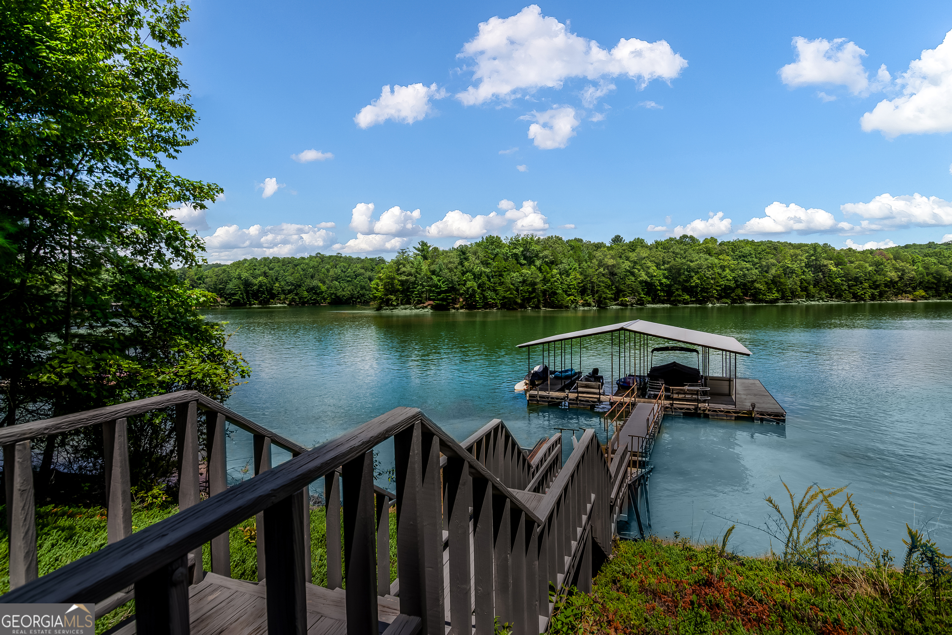 a view of a lake with a deck in the patio