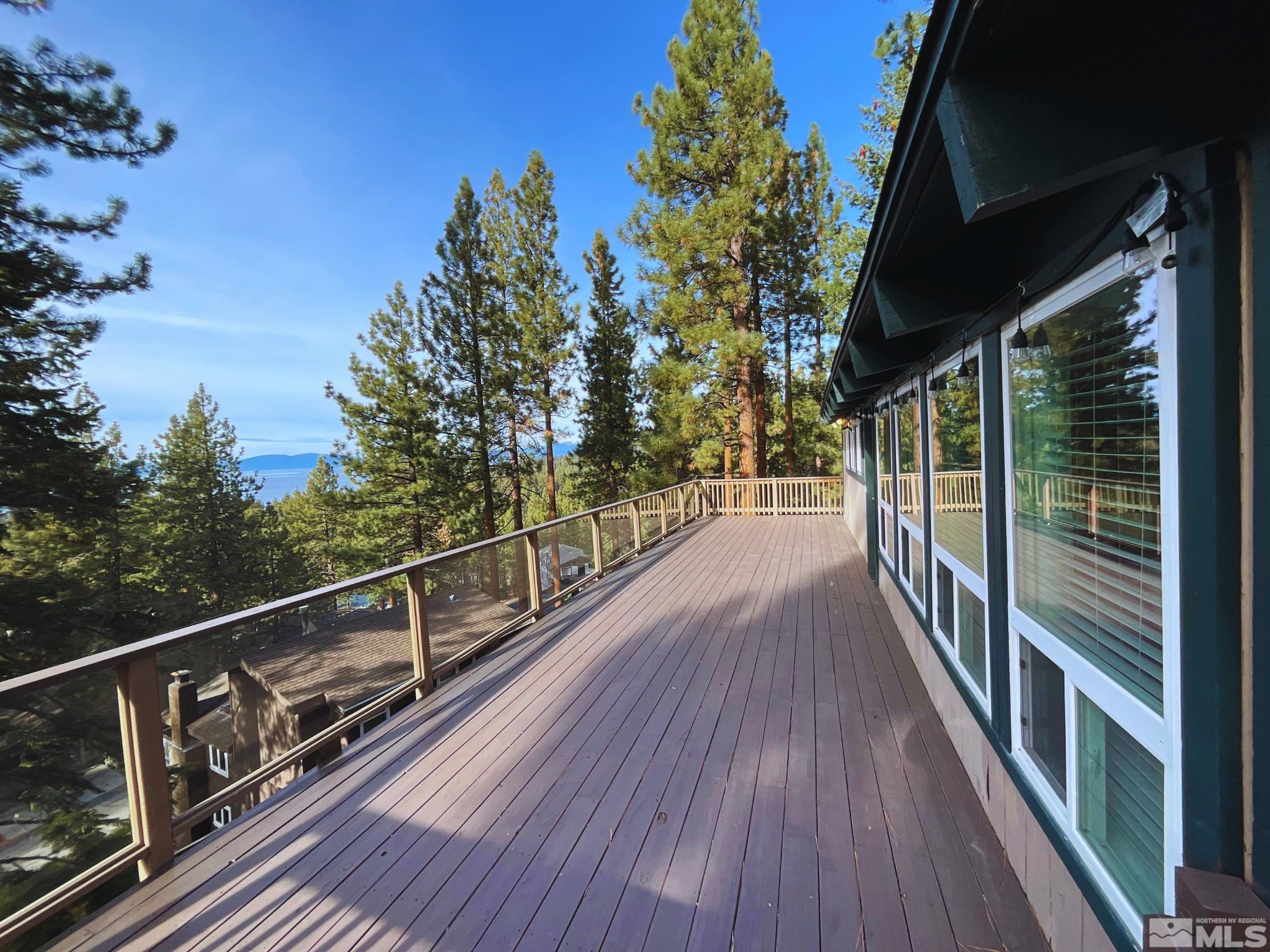 a view of balcony with wooden floor and fence