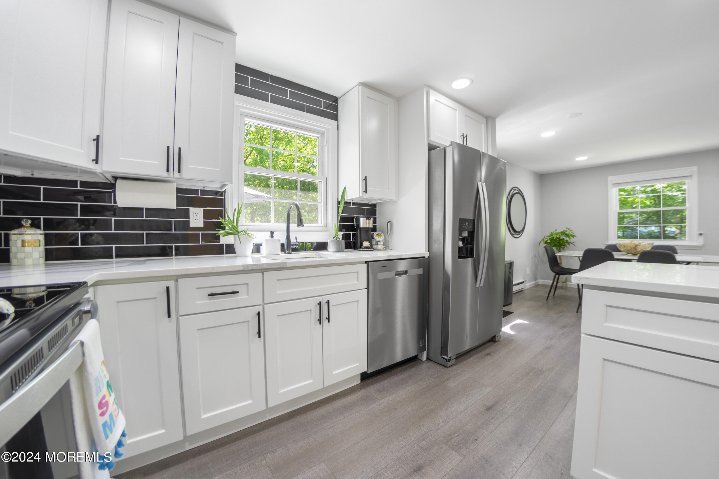 a kitchen with white cabinets and white appliances