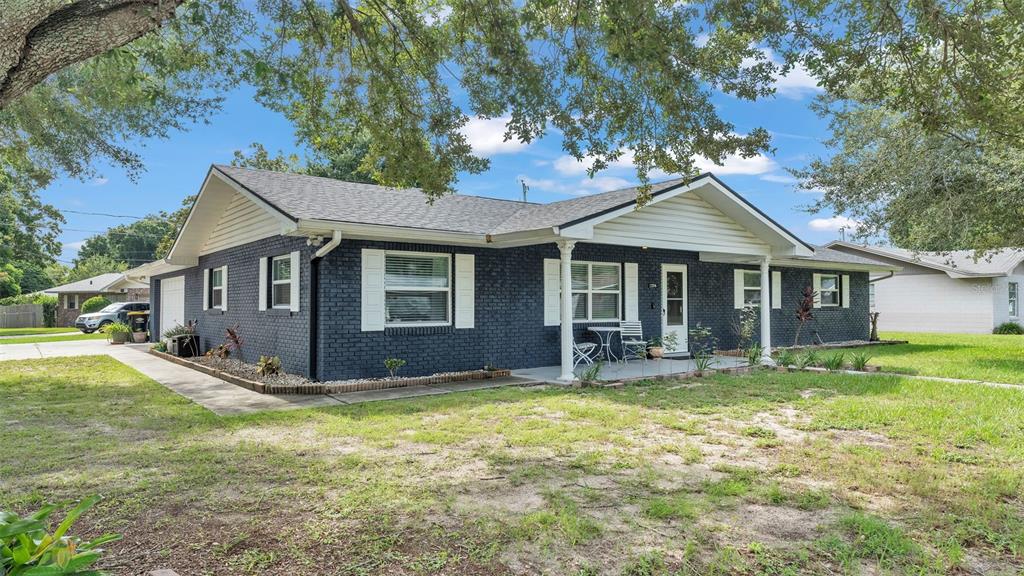 a front view of a house with a yard and porch