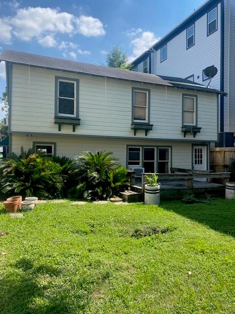 a view of a house with a yard and sitting area