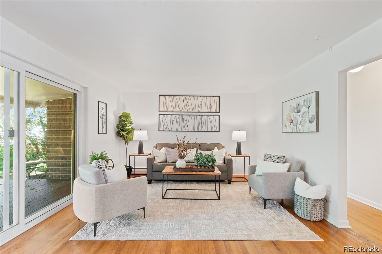 a living room with furniture and wooden floor