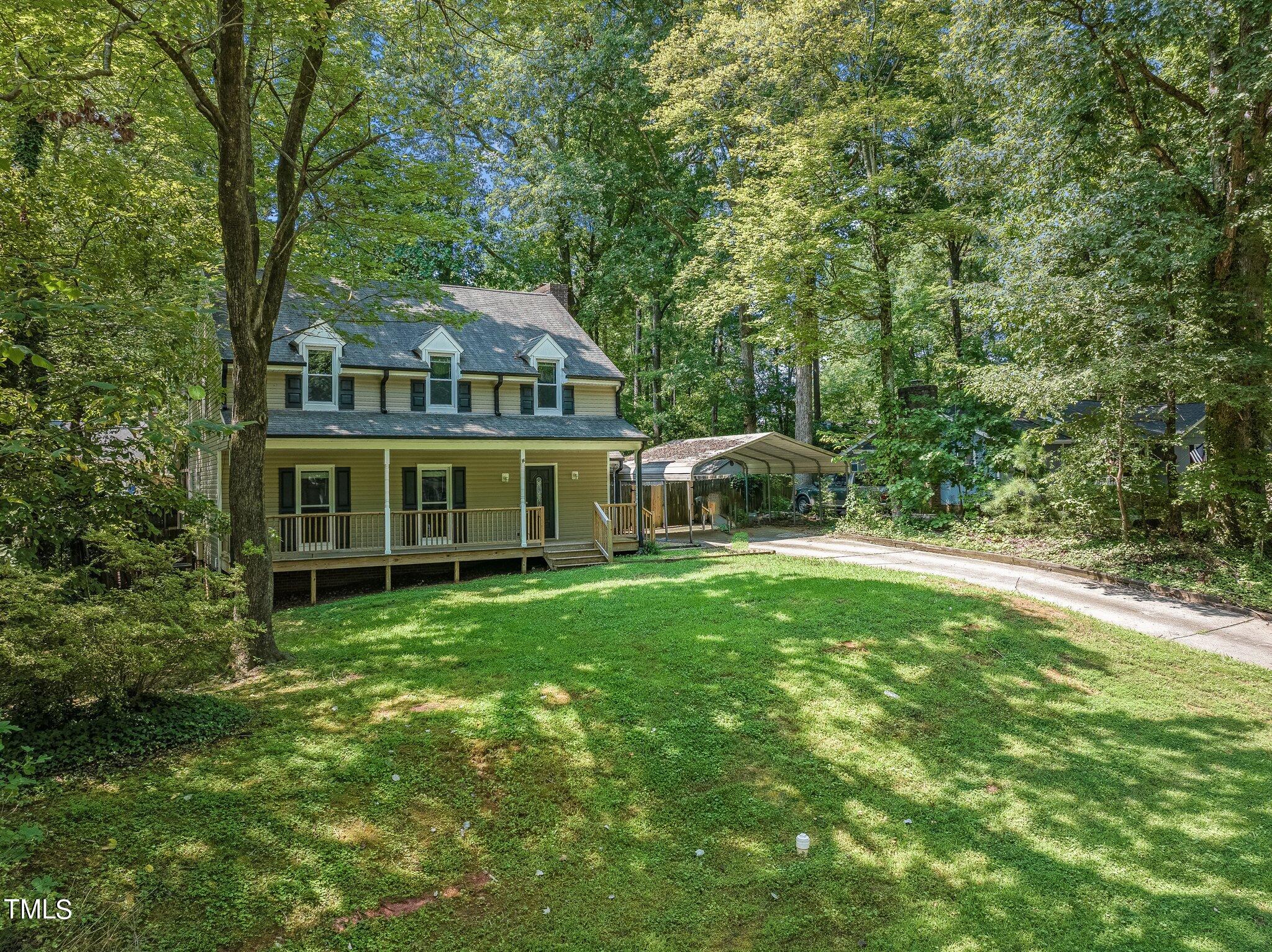 a view of a house with a yard balcony and swimming pool