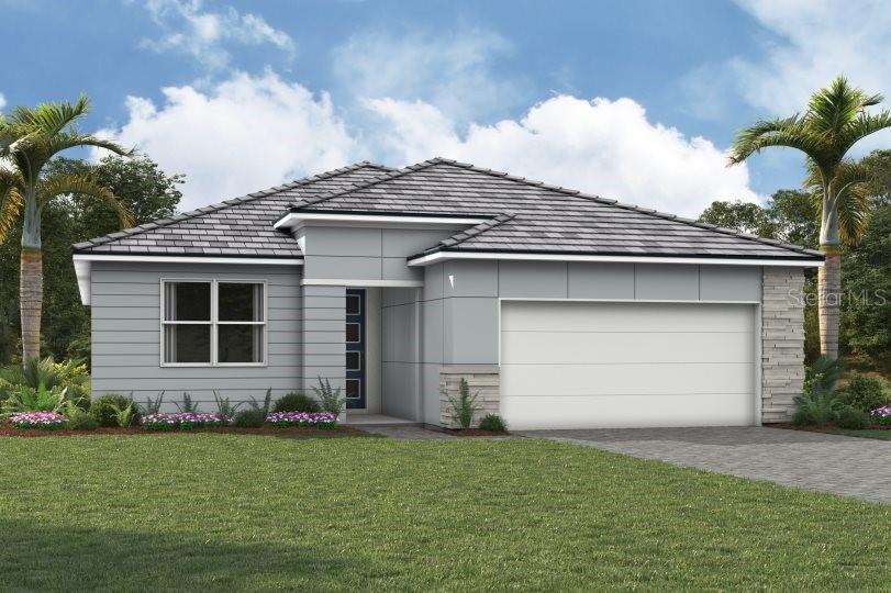 a front view of a house with a garden and garage