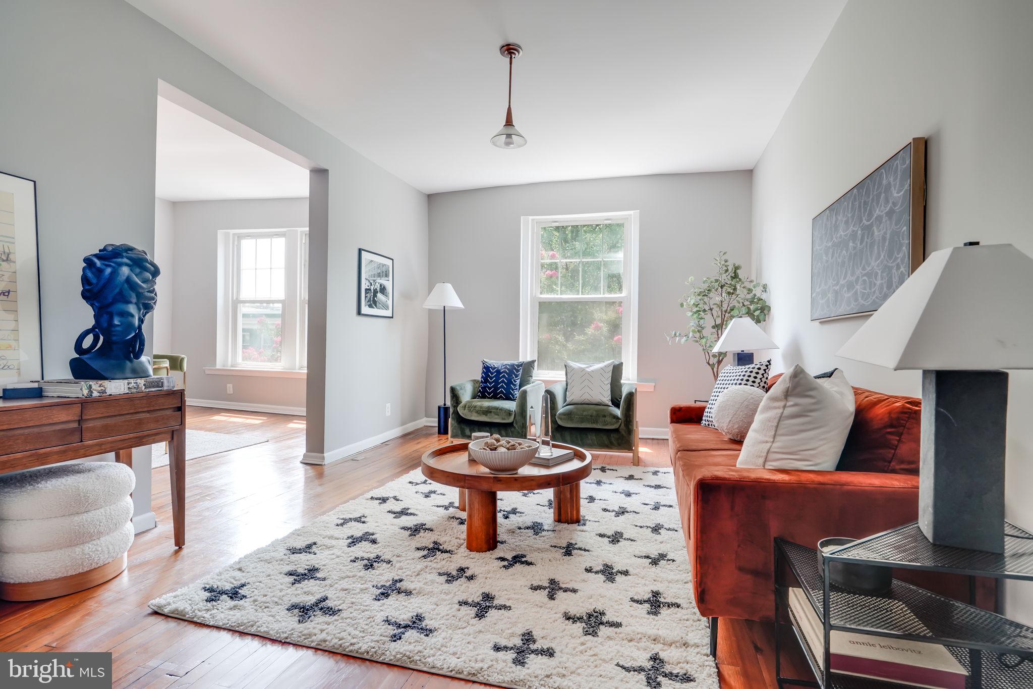 a living room with furniture a rug and a window