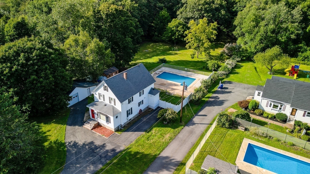 an aerial view of a house with a yard