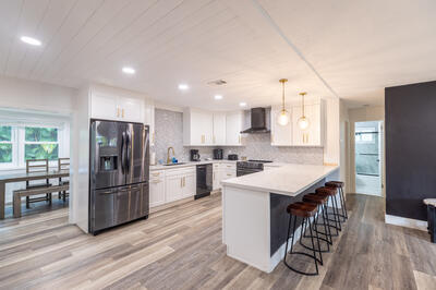 a kitchen with refrigerator cabinets and wooden floor