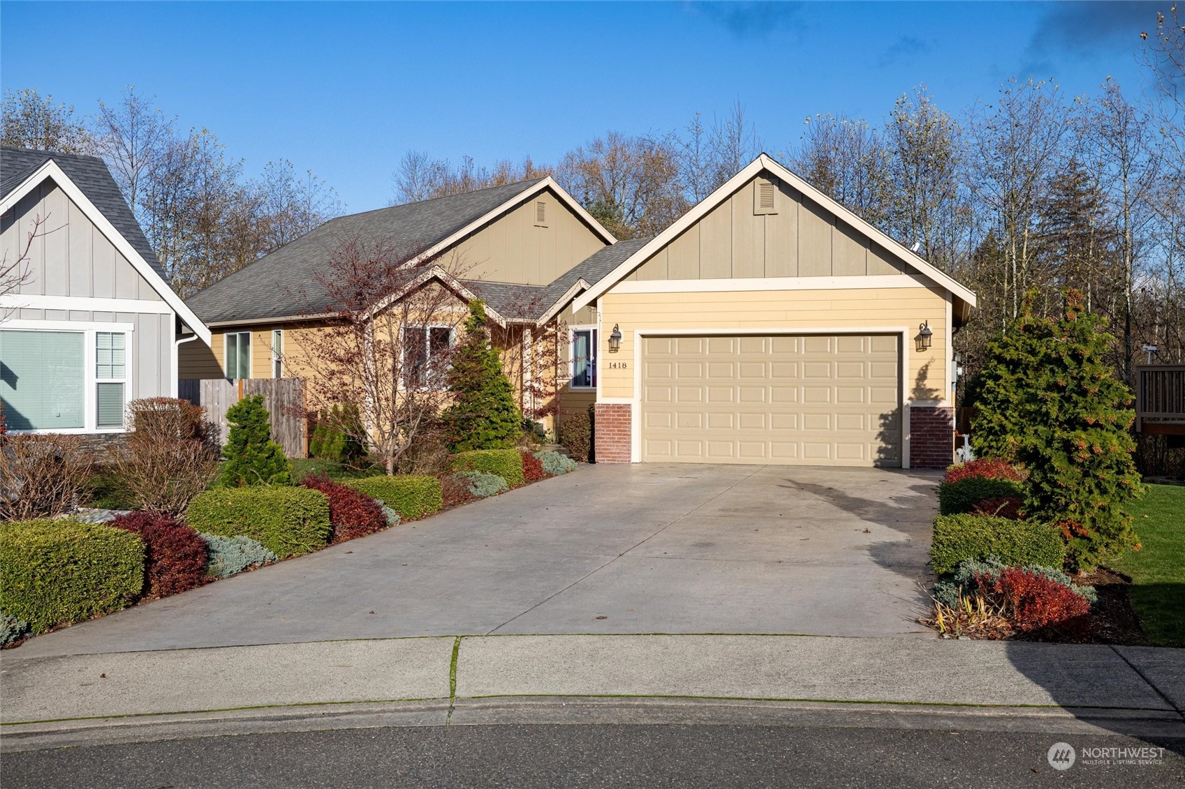 a view of a house with a yard and garage