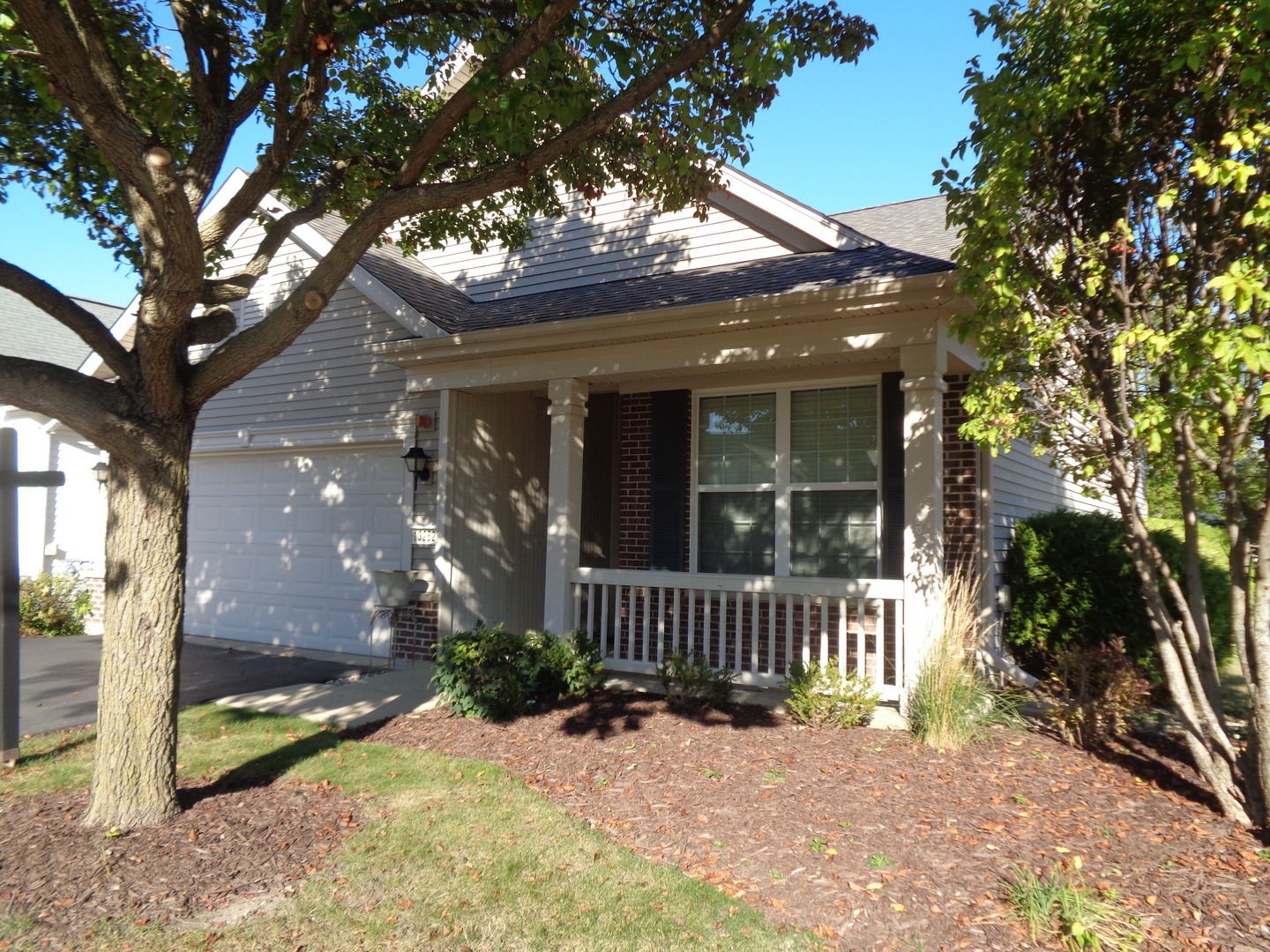 a view of a house with a yard and garden