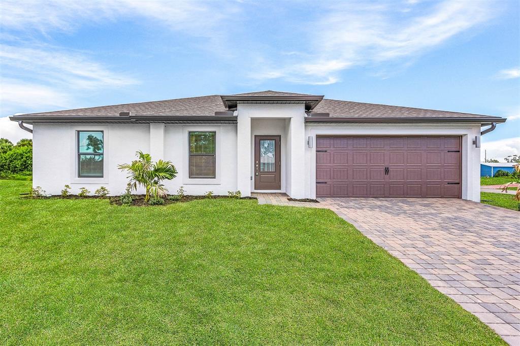 a front view of house with yard and outdoor seating