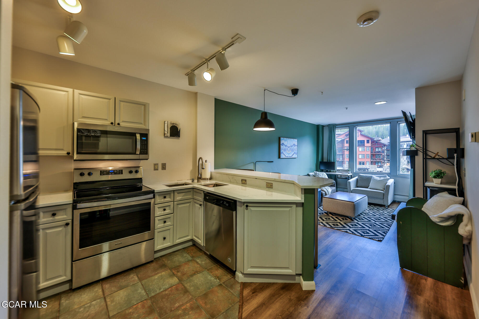 a view of kitchen with sink and stainless steel appliances