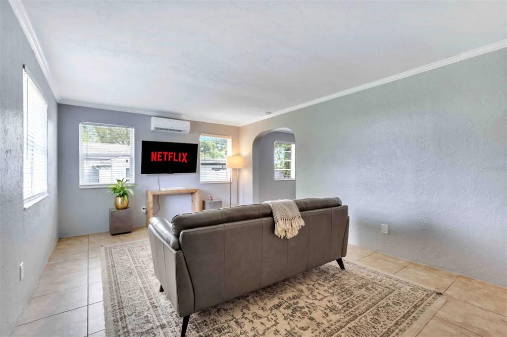 a living room with furniture and a flat screen tv