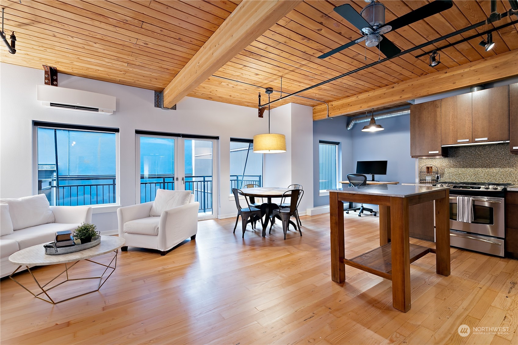 a living room with furniture and kitchen view