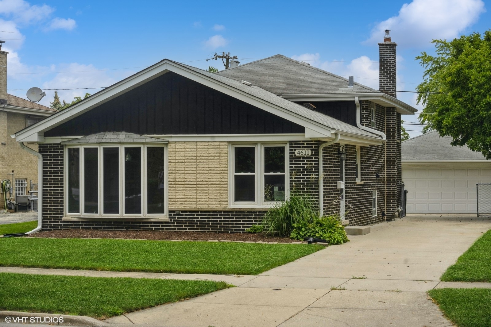 a front view of a house with a garden