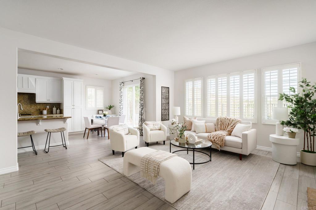 a living room with furniture and view of kitchen